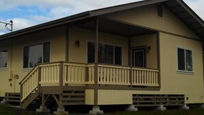 A two-story house with a front porch, a staircase, and a garage.