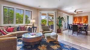 A spacious living area with a sofa, armchairs, a coffee table, and a dining area with chairs and a table. - The Maui Escape - Spectacular 2.5 Bdr Penthouse -Oceanfront Resort-Owner Direct! (Wailea)