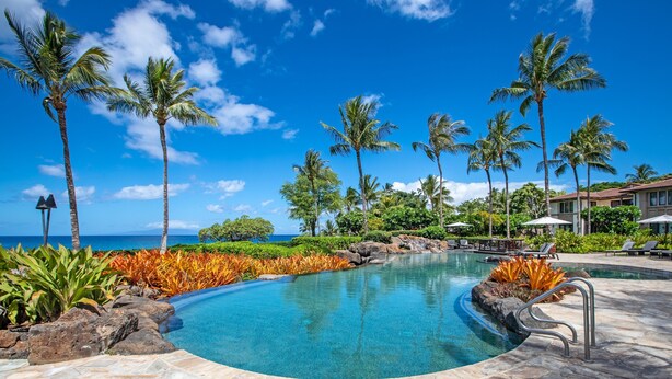 A pool with clear blue water, surrounded by palm trees and a view of the ocean. - The Maui Escape - Spectacular 2.5 Bdr Penthouse -Oceanfront Resort-Owner Direct! (Wailea)