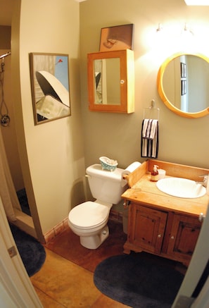 A bathroom with a toilet, sink, mirror, and a framed picture on the wall. - No cleaning fee. Close to downtown via direct bus. Private & beautiful view. (Seattle)