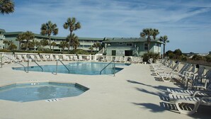 A pool area with multiple swimming pools, lounge chairs, and palm trees. - Oceanfront, One-Bedroom & Balcony, 50" Flat TV, Aug. 30- Sept.3- SPL Rates! (Isle of Palms)