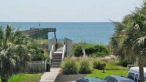 A coastal property with a staircase leading to a wooden deck overlooking the sea. - Oceanfront, One-Bedroom & Balcony, 50" Flat TV, Aug. 30- Sept.3- SPL Rates! (Isle of Palms)
