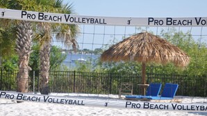 A beach volleyball net labeled "Pro Beach Volleyball" with a thatched umbrella and blue chairs in the background. - Bahama Bay Highest Rated, best Location 3BR/2Bath, Recently Renovated 3rd Floor (Davenport)