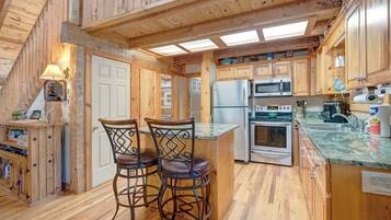 Dishwasher, coffee/tea maker, cookware/dishes/utensils, dining tables