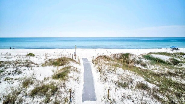A beach path leading to the ocean with white sand and sparse vegetation. - Beautiful Town Home Beach Rental In Perdido Key Florida - Pool + Beach Access (Perdido Key)