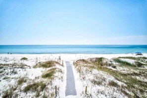 A beach path leading to the ocean with white sand and sparse vegetation. - Beautiful Town Home Beach Rental In Perdido Key Florida - Pool + Beach Access (Perdido Key)