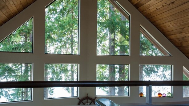 A room with large windows offering views of tall trees. - Waterfront Getaway, Beautiful Hood Canal (Brinnon Wa)