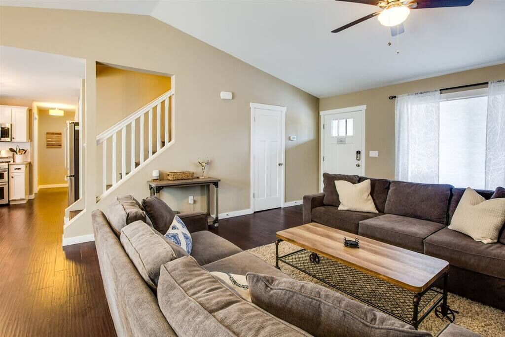 A living room with a sofa set, a coffee table, and a ceiling fan.