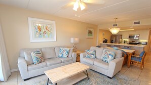 A living room with a sofa set, a coffee table, and a patterned rug. - Experience comfort in this 2-bedroom condo with a bonus room, perfect for 8 guests. (South Padre Island)