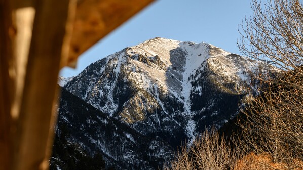 A mountain with snow-covered peaks and a clear sky.