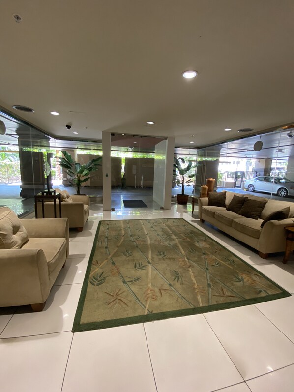 Relax in comfort with plush sofas and a cozy seating area, surrounded by a beautiful view of the street outside.