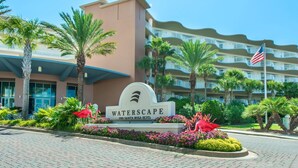 A hotel entrance with a sign reading "WATERSCAPE" and "1100 Santa Rosa Blvd."