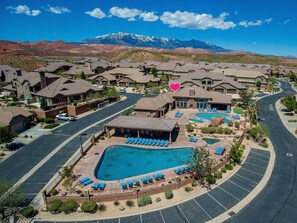A resort with multiple buildings, a swimming pool, and a mountain backdrop. - Coral Ridge Retreat 1! Right Across the Street from Pools! (Washington)