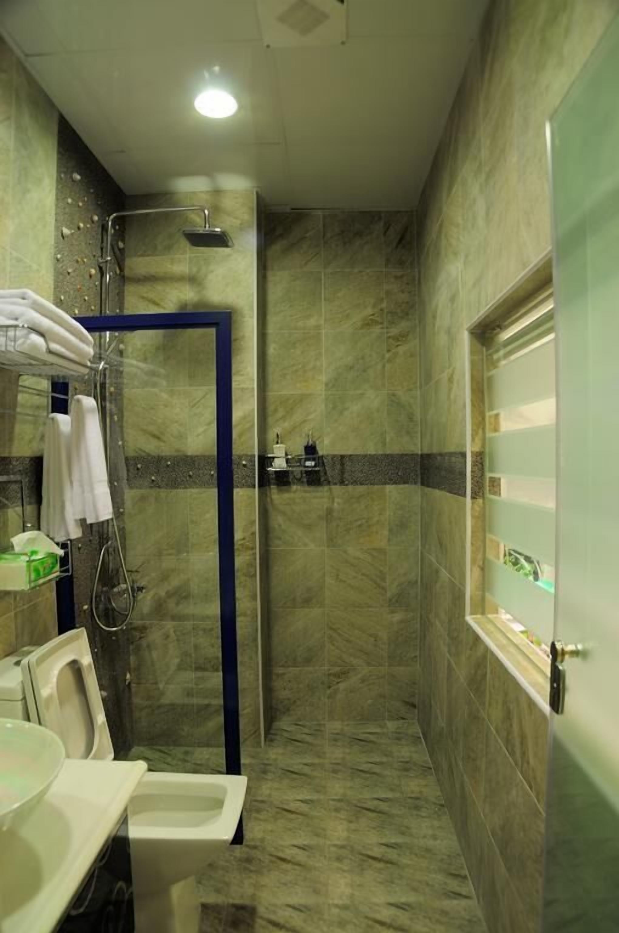 Un baño con ducha, inodoro y lavamanos.
