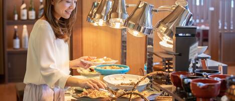 A buffet setup with various dishes and a coffee machine.