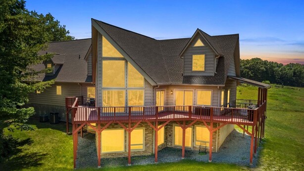 A large house with a prominent balcony and a second-story deck.
