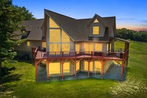 A large house with a prominent balcony and a second-story deck.