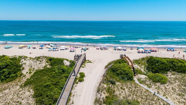 A beach with a wooden boardwalk, sandy beach, and ocean view. - 632 Private Pool, Hot Tub, Billiards, and More! (Corolla)
