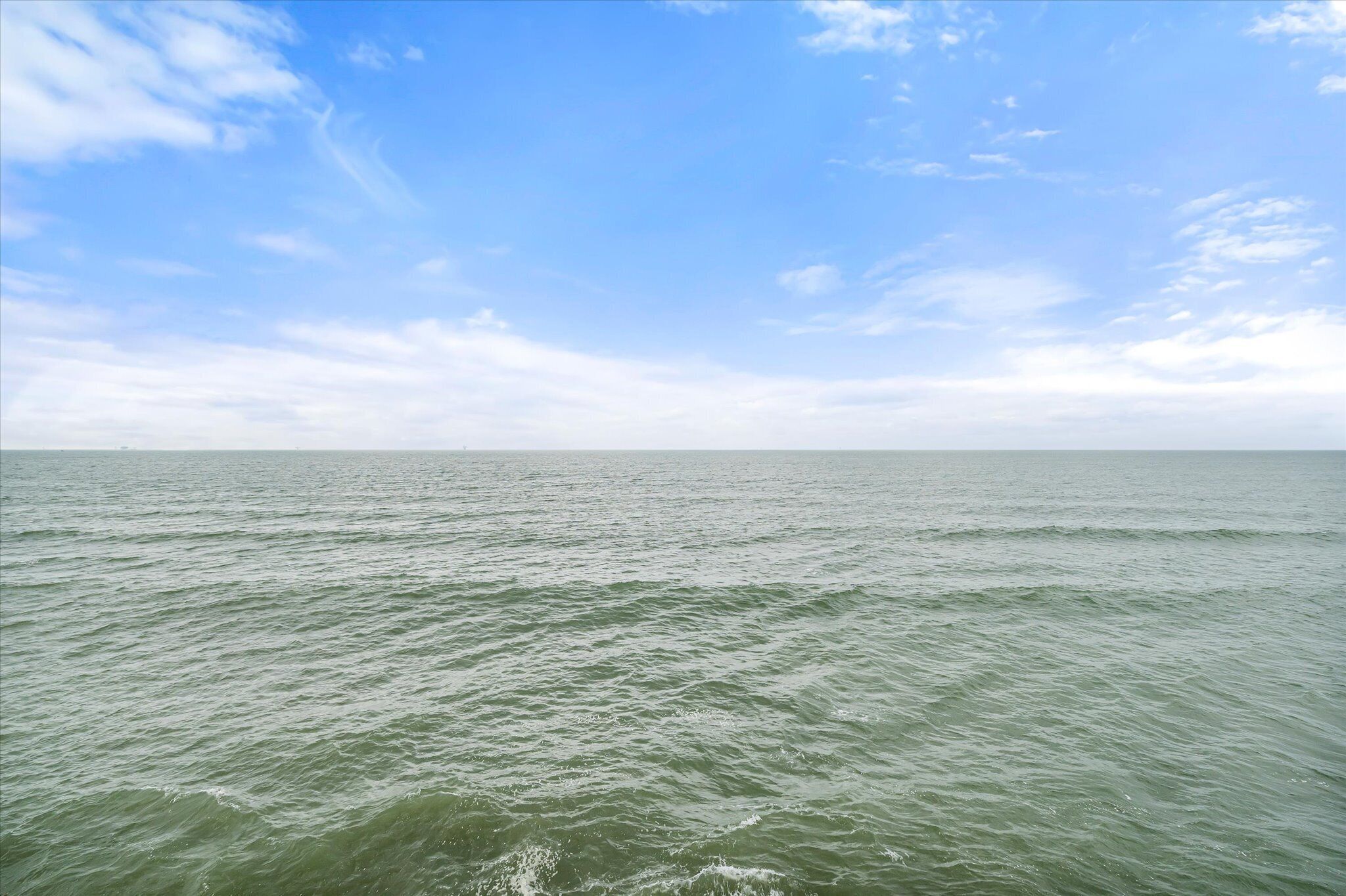 A view of a calm sea under a clear sky.
