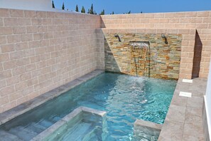A swimming pool with stone walls and a clear blue water feature. - Bungalow for 4 people with free Wi-Fi (CONIL DE LA FRONTERA)