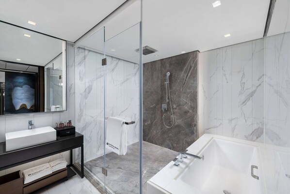 A modern bathroom with a large white sink, a glass-enclosed shower, and a freestanding bathtub. - Wyndham Grand Yangon Hotel (Yangon)