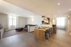 Enjoy meals and social gatherings in the central island dining area with a comfortable sofa nearby.