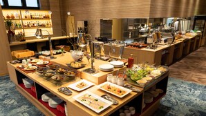 A buffet setup with various food items and utensils.