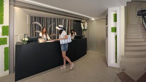 A reception desk with a modern design, a staircase, and green wall accents. - Hotel & Residence Continental (Gabicce Mare)