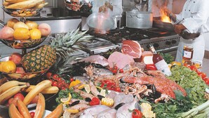 A kitchen with chefs preparing food, a variety of fruits and vegetables, and cooking equipment. - Hotel & Residence Continental (Gabicce Mare)
