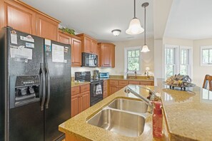 Dishwasher, coffee/tea maker, cookware/dishes/utensils, dining tables