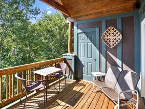 Relax in a serene outdoor space with a deck and comfortable seating for two.
