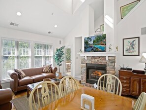 Relax in this stylish living room with a fireplace, flat-screen TV, and dining area for four.