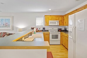 Dishwasher, coffee/tea maker, cookware/dishes/utensils, dining tables