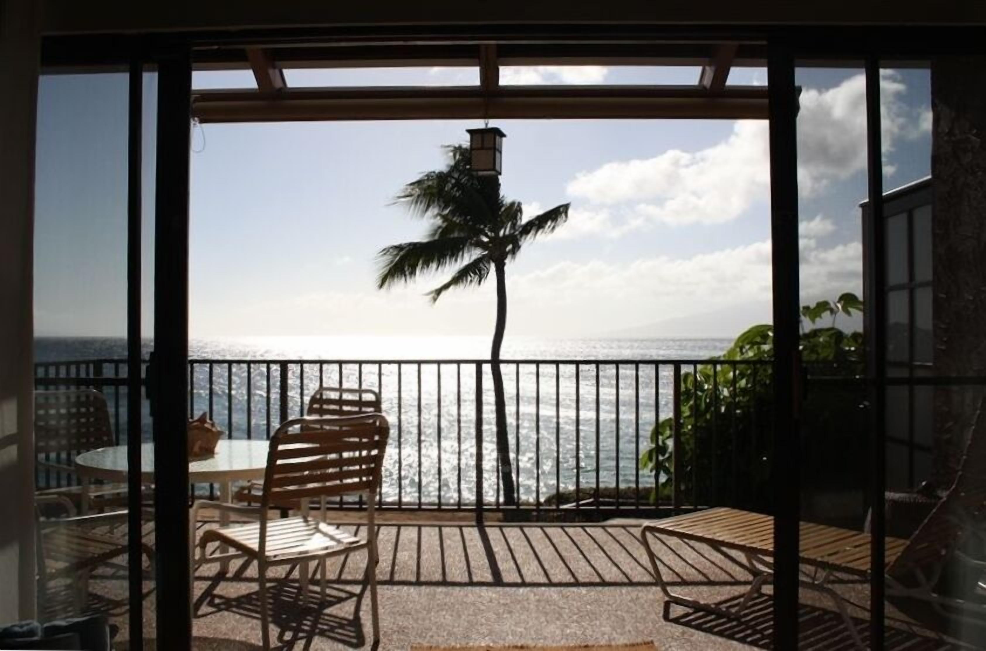 The living room looks onto a large lanai and has a panoramic ocean view.