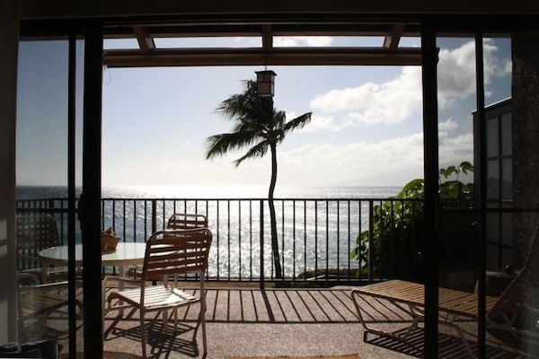 The living room looks onto a large lanai and has a panoramic ocean view.