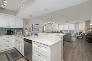 Fridge, dishwasher, coffee/tea maker, cookware/dishes/utensils