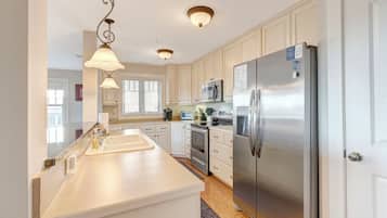 Dishwasher, coffee/tea maker, cookware/dishes/utensils, dining tables