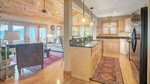 A spacious kitchen with wooden cabinets, a central island, and pendant lighting. - Grand Oaks RS6- Mountain Condo, Gated Resort, Indoor/Outdoor Pools & Hot Tub (Banner Elk)