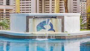 A swimming pool with a dolphin mosaic and a waterfall feature. - Sandy Shanty: Luxurious Beach House with Rooftop Ocean Views! (Isle of Palms)