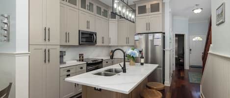 Fridge, dishwasher, coffee/tea maker, cookware/dishes/utensils