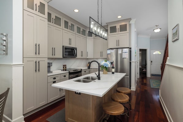 Fridge, dishwasher, coffee/tea maker, cookware/dishes/utensils