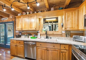 Dishwasher, coffee/tea maker, cookware/dishes/utensils, dining tables