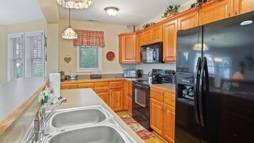 Dishwasher, coffee/tea maker, cookware/dishes/utensils, dining tables