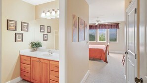 A bedroom with a bed, a window, and a door. - Wintergreens R1112- Mtn Condo/View, Gated Resort, Indoor/Outdoor Pools & Hot Tub (Banner Elk)