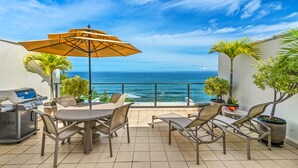 A patio with a grill, outdoor seating, and a view of the ocean. - WORLD CLASS#402 Superior PENTHOUSE, Full AC, 2 Suites, Best Views & Privacy (Princeville)