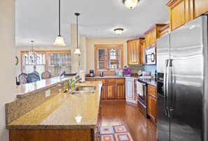 Dishwasher, coffee/tea maker, cookware/dishes/utensils, dining tables