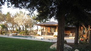 A house with a swimming pool, surrounded by trees and a well-maintained lawn. - Private Ranch House Resort (Templeton)