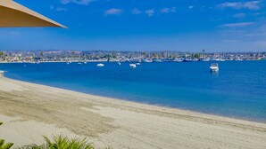 A beach with a clear view of the ocean and a marina with boats. - Right On The Beach! Exquisitely Remodeled 3BR/3BA . Perfect For Families. (San Diego)