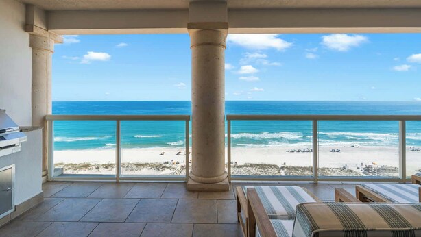 A balcony with a view of the ocean, a grill, and seating area. - Beach Club 1005 - 𝑨𝒒𝒖𝒂 𝑶𝒂𝒔𝒊𝒔 (Pensacola Beach)