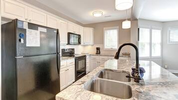 Dishwasher, coffee/tea maker, cookware/dishes/utensils, dining tables